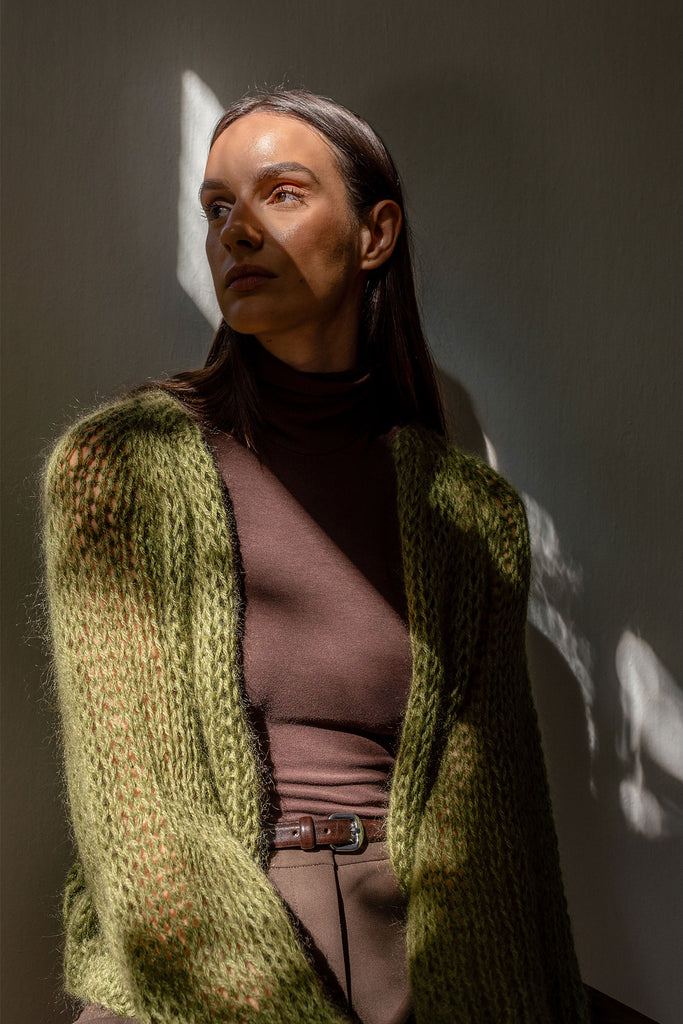 Woman with hand knit mohair cardigan in khaki green