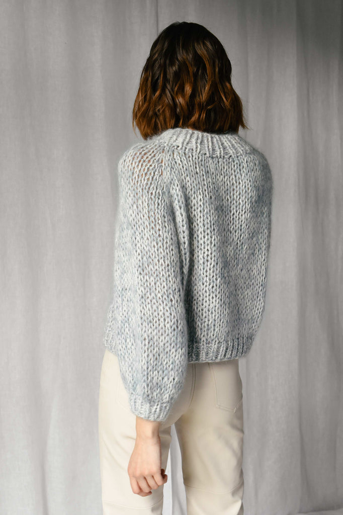 Back of the chunky braid sweater in light blue color
