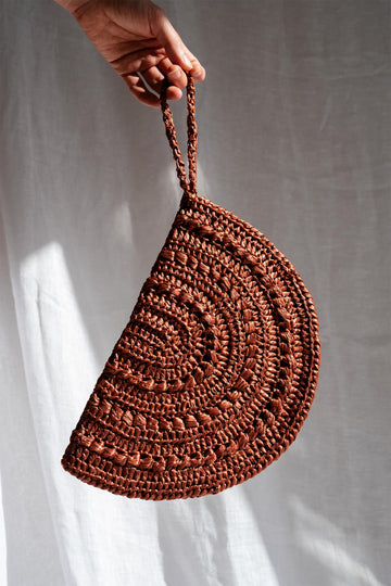 Crochet raffia moon clutch in rust color