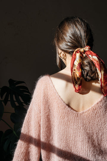 Deep v neckline of the mohair sweater in powder pink color