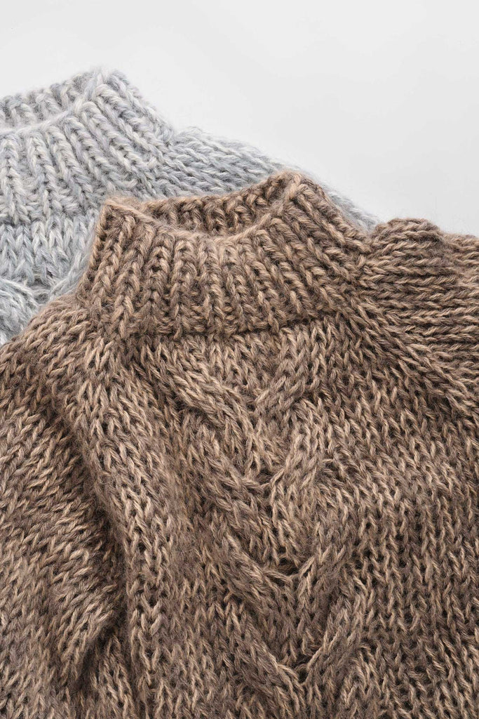 Detail of the chunky braid sweater in stone mix