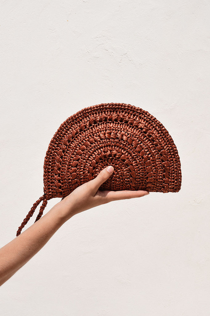 Raffia moon clutch in rust color