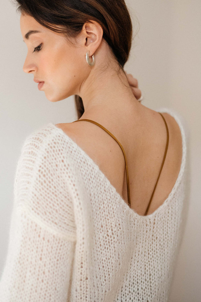 The v neckline of the mohair sweater in cloud off white color