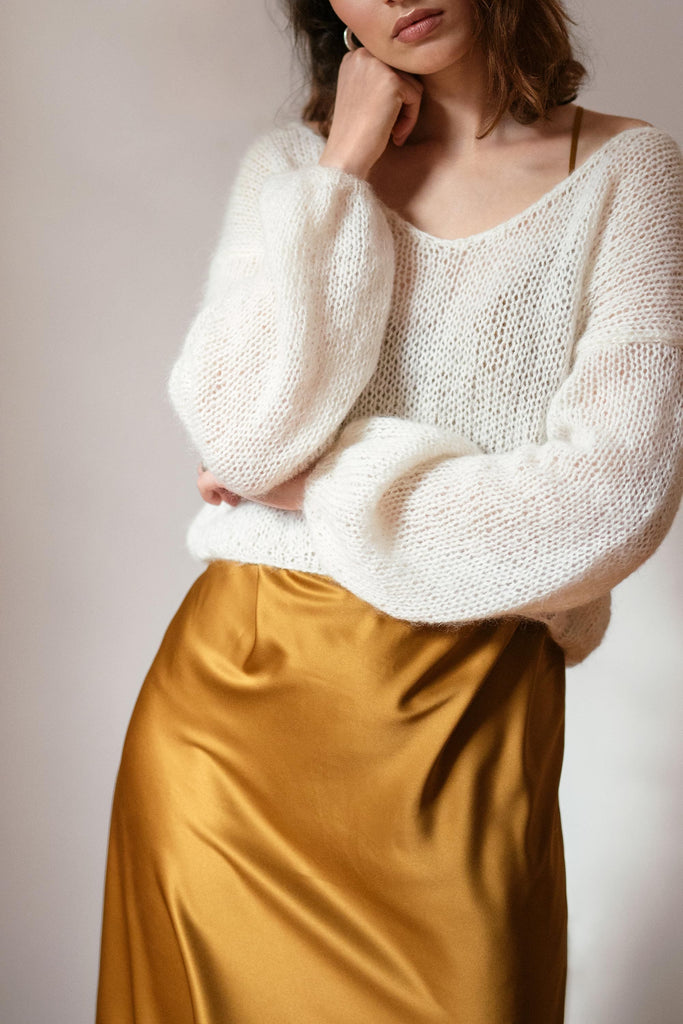 The voluminous sleeves of the mohair deep v sweater in cloud