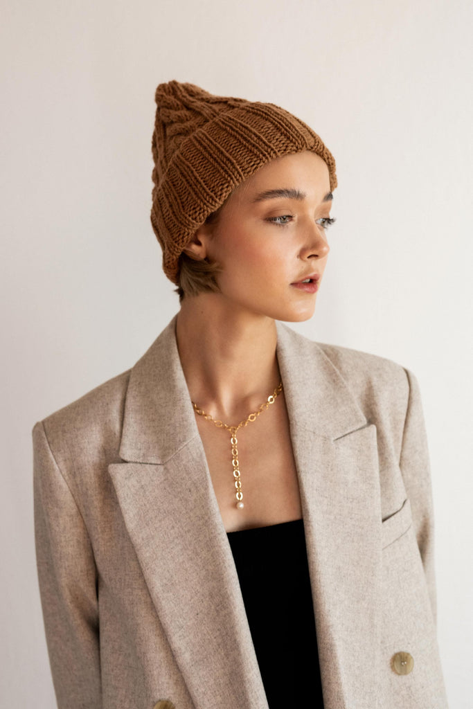Wool beanie hat with cable pattern in caramel